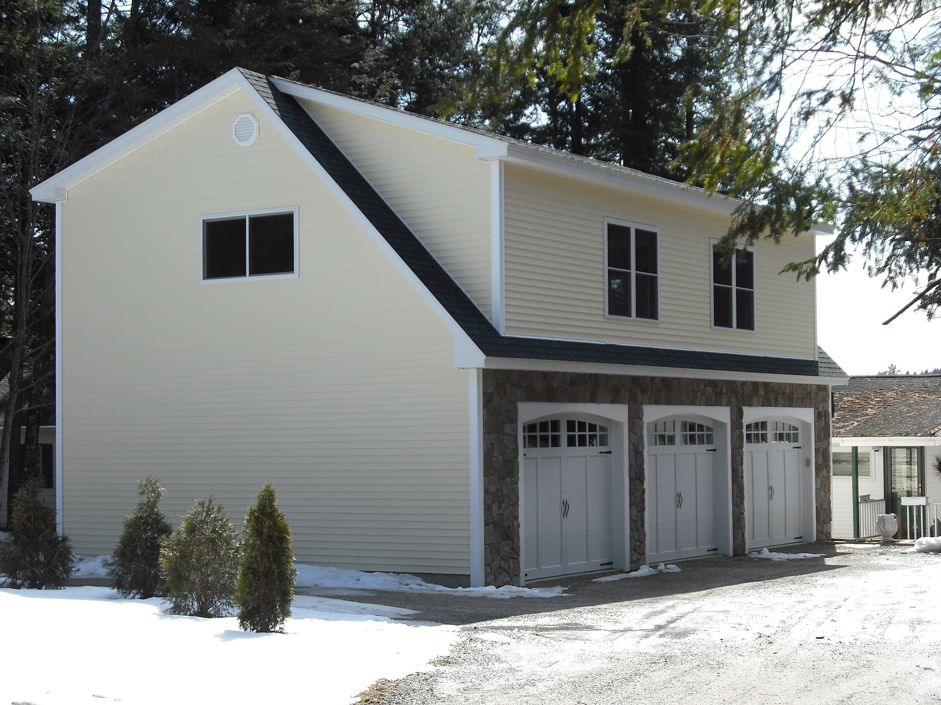 Colby garage with stone base and three bays