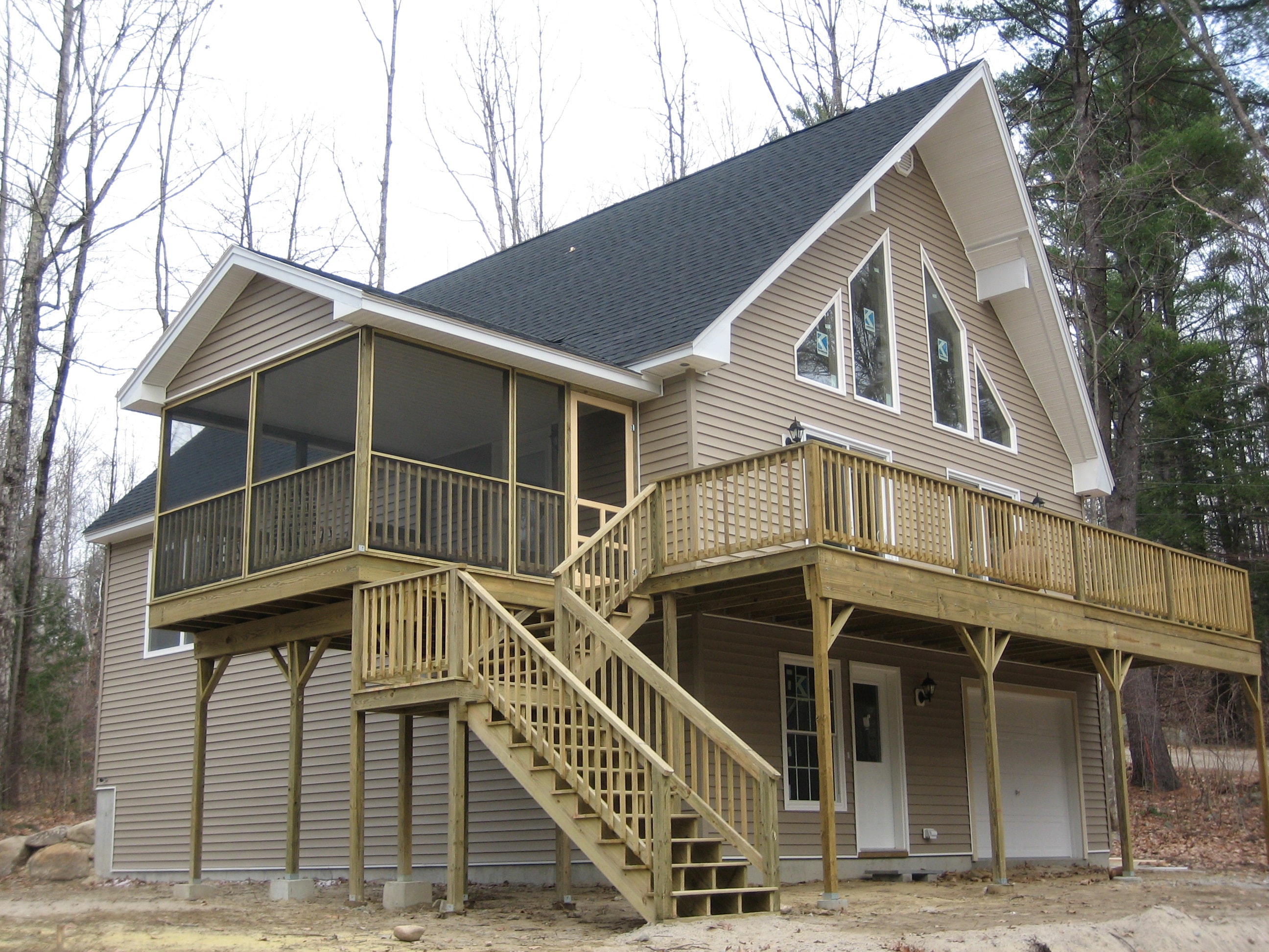 Whitefield home exterior with screened porch and drive-under